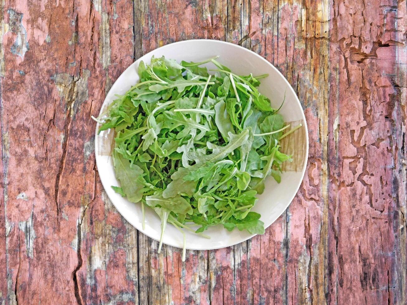 Arugula On Wooden Background photo