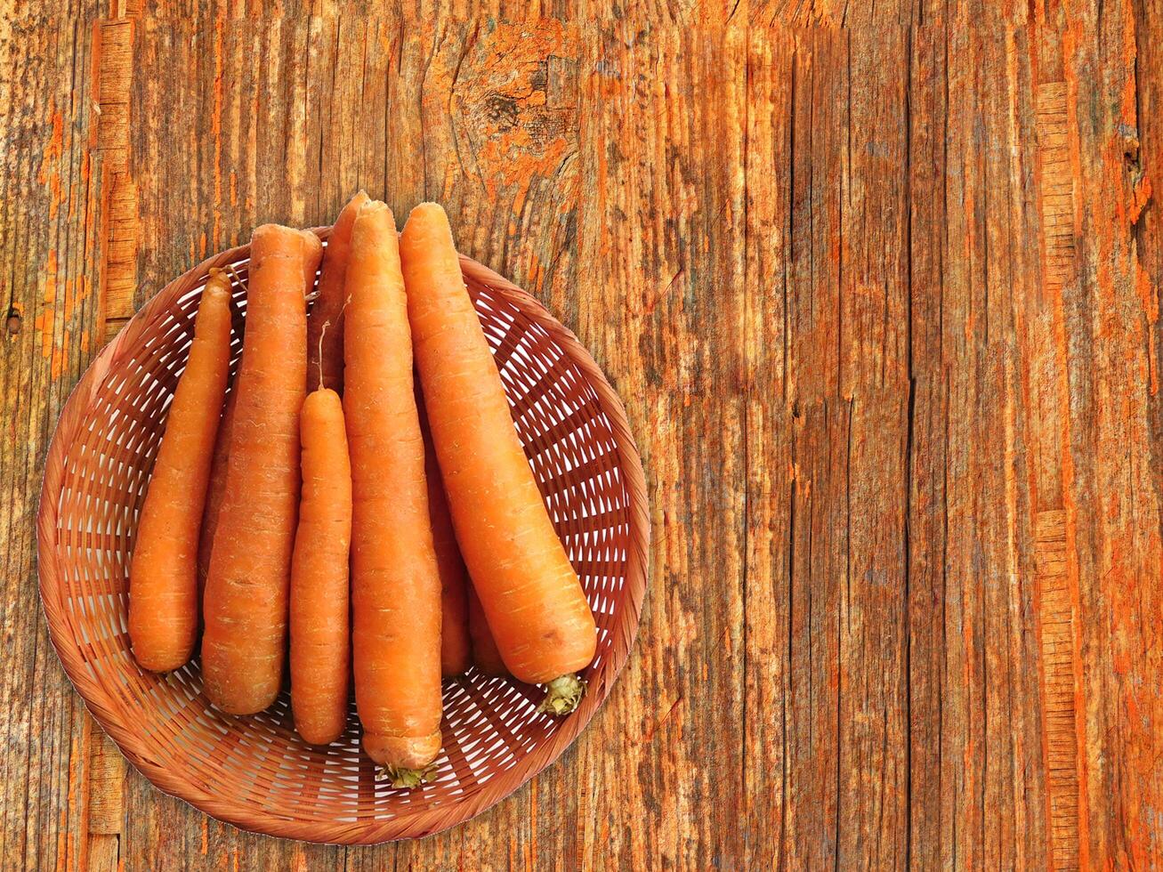 Carrots On The Wooden Background photo