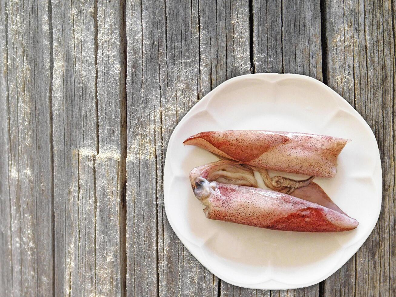 Squid On Wooden Background photo