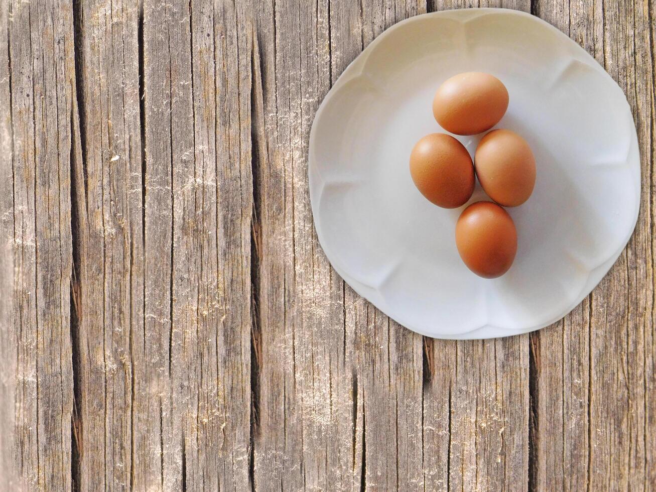 Eggs On The Wooden Background photo