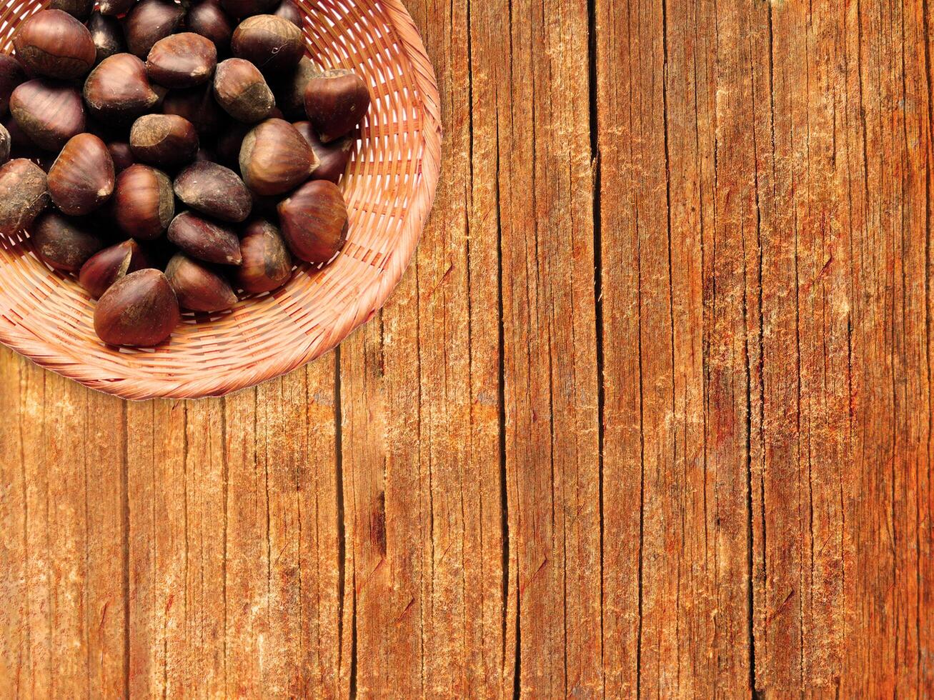 Chestnuts On The Wooden Background photo