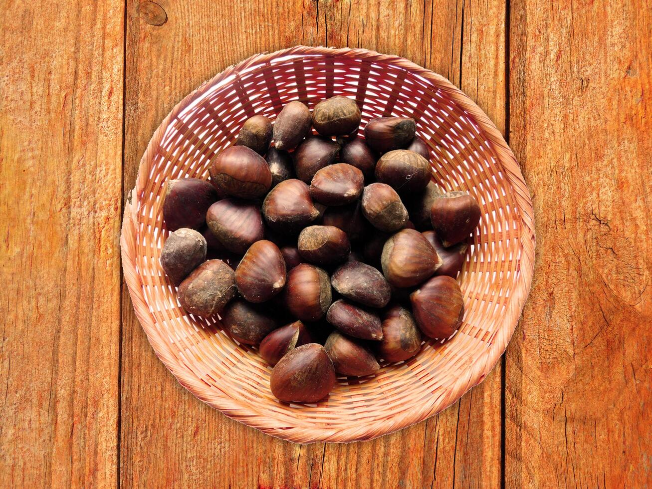 Chestnuts On The Wooden Background photo