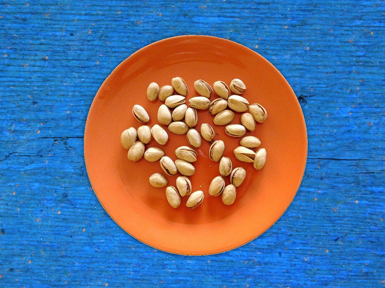 Pistachios On The Wooden Background photo