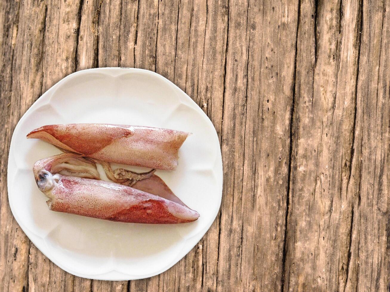 Squid On Wooden Background photo