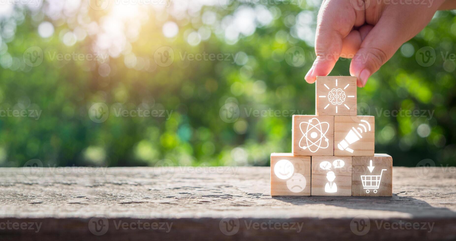 Neuromarketing concept, Hand holding wooden block on desk with neuromarketing icon on virtual screen. photo