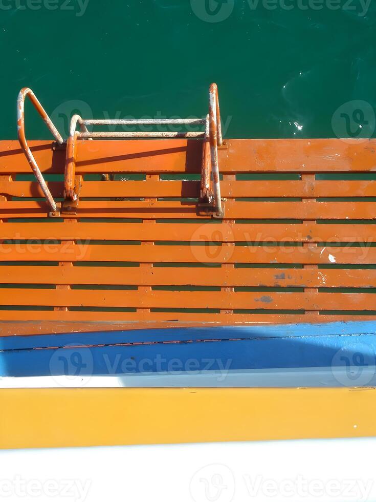 Wooden boat steps to the sea under a summer sky photo