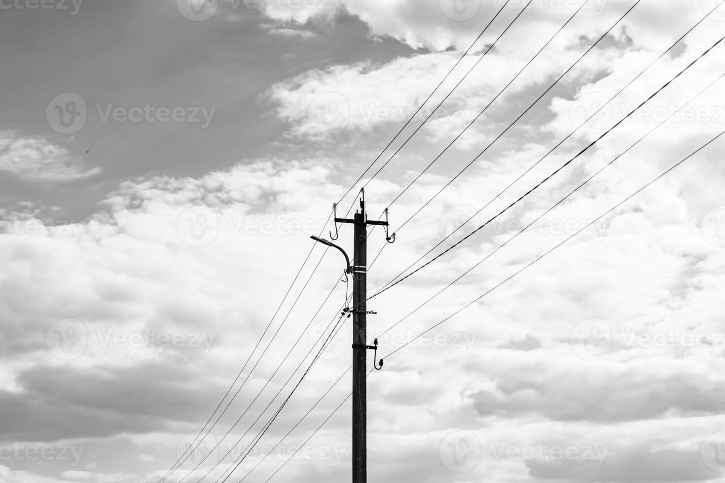 Power electric pole with line wire on dark background close up photo