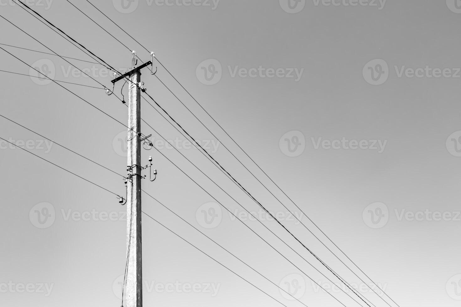 Power electric pole with line wire on light background close up photo