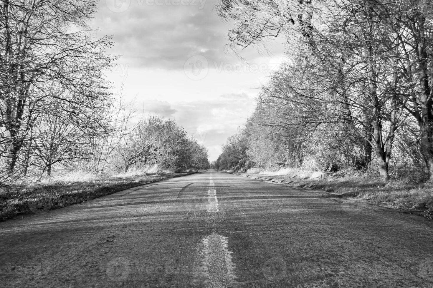 Beautiful empty asphalt road in countryside on colored background photo