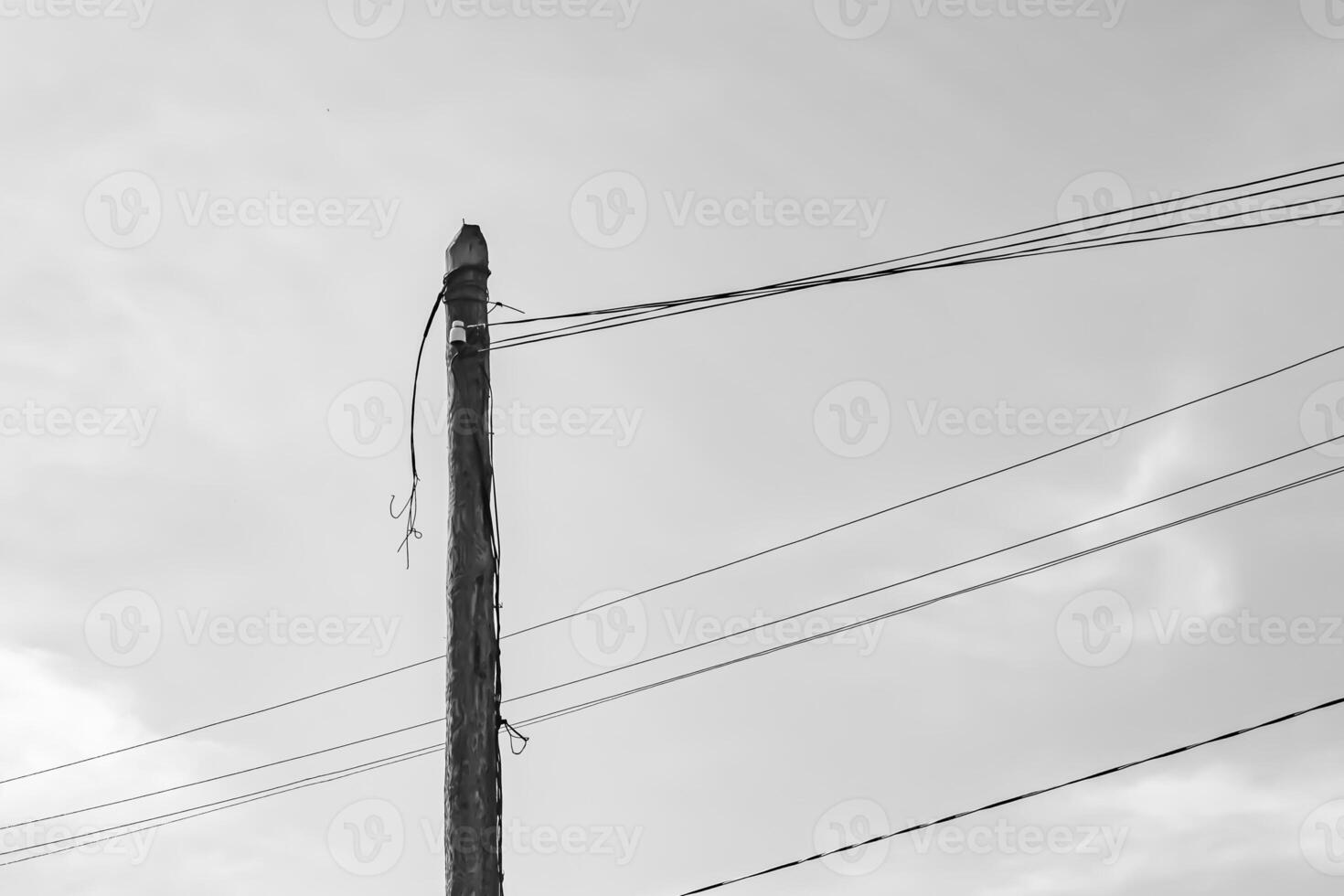 Power electric pole with line wire on light background close up photo