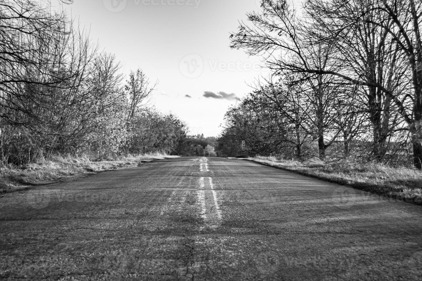 Beautiful empty asphalt road in countryside on colored background photo