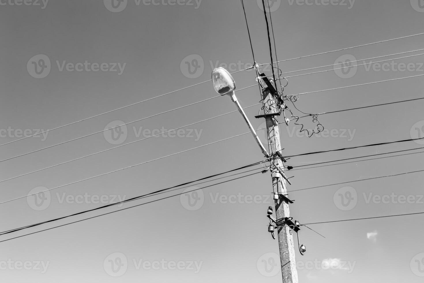 Power electric pole with line wire on light background close up photo