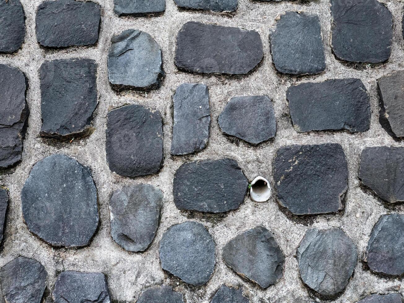 a pattern of natural stone that is usually used as a building foundation photo