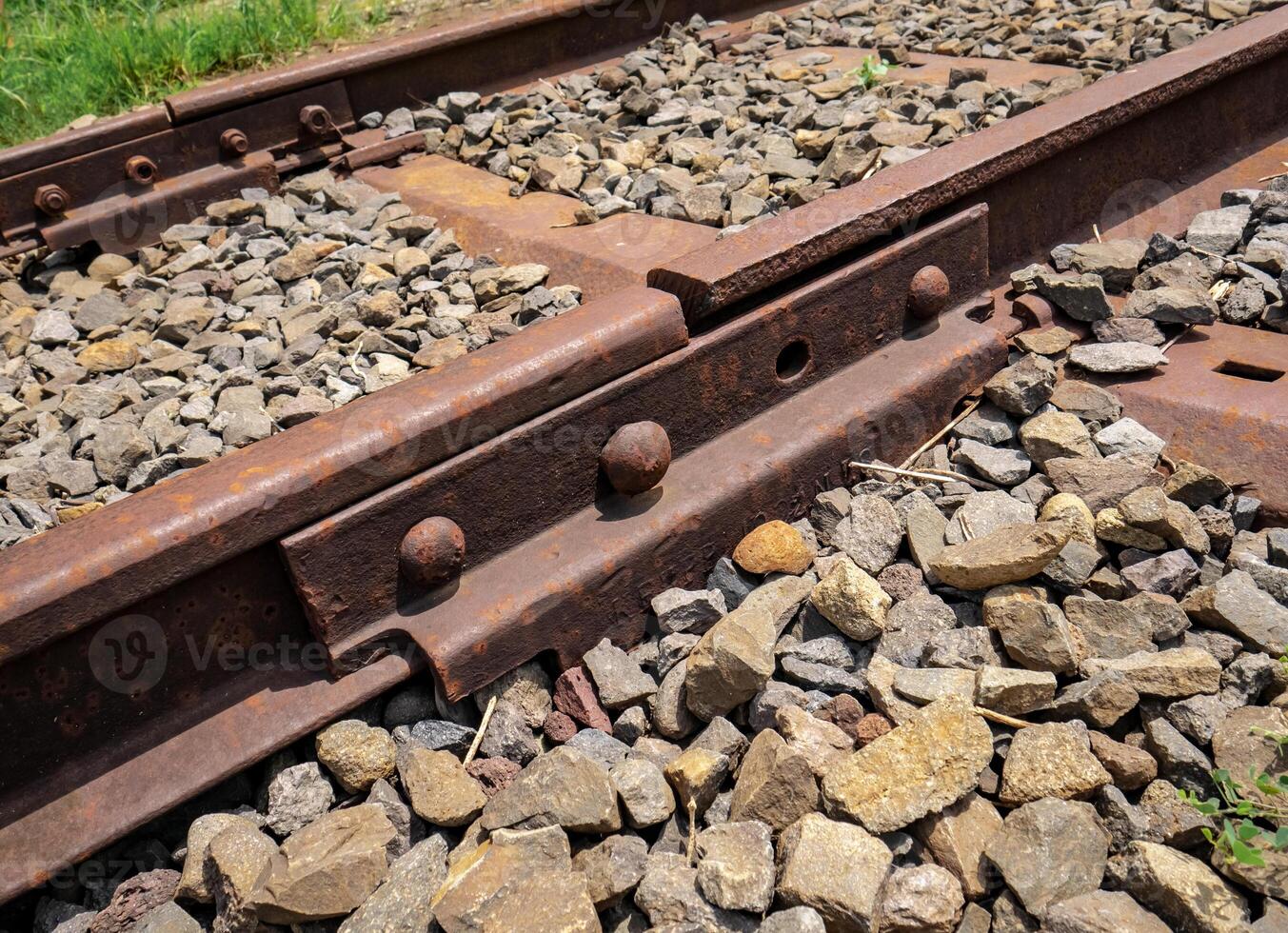 iron joints on the railroad tracks that look rusty brown photo