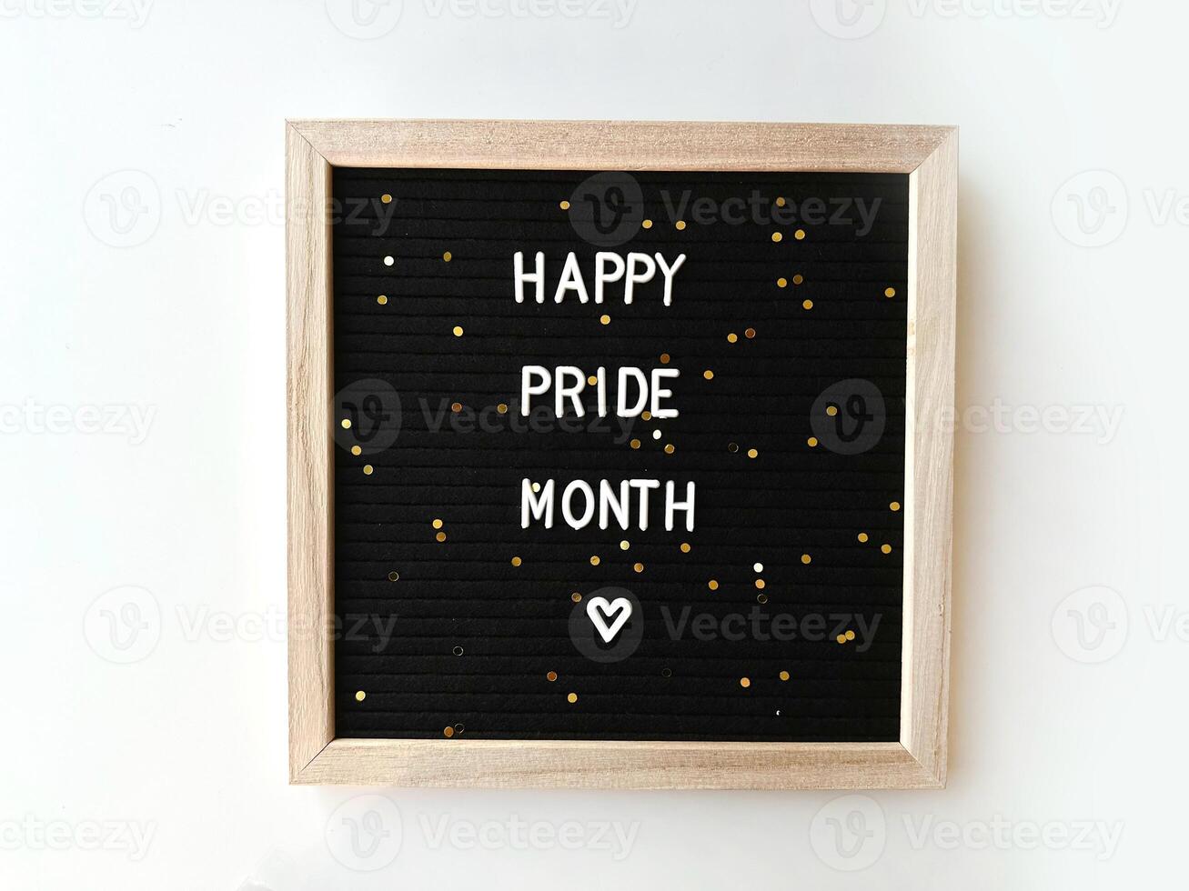 Happy Pride Month text on the Letter board. Happy pride month spelled with craft white letters over black sandwich board. Concept of Greeting card minimalist background. photo