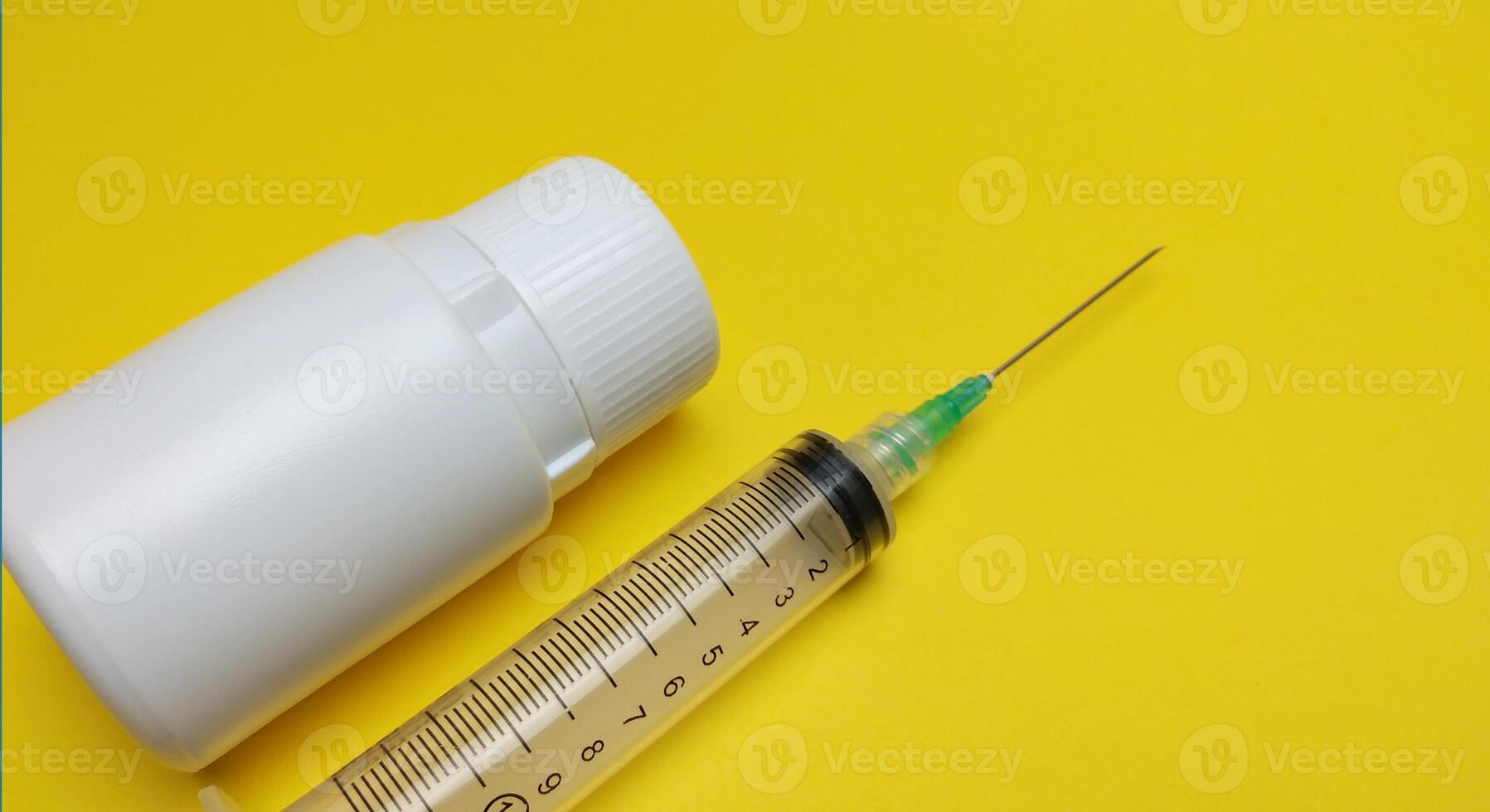 injectable pill medication on a yellow background photo