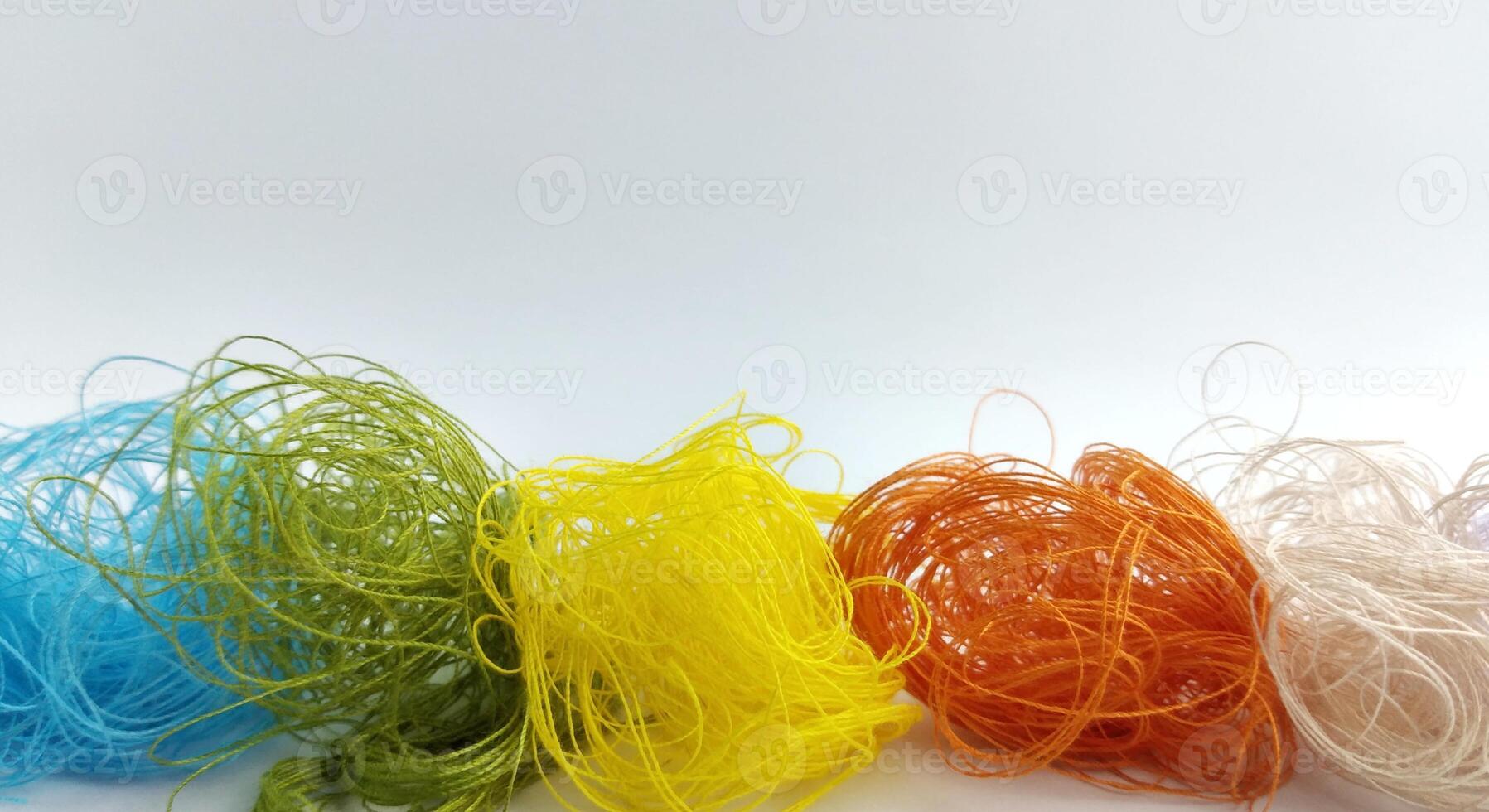 Colorful threads on a white background close-up. Selective focus. photo