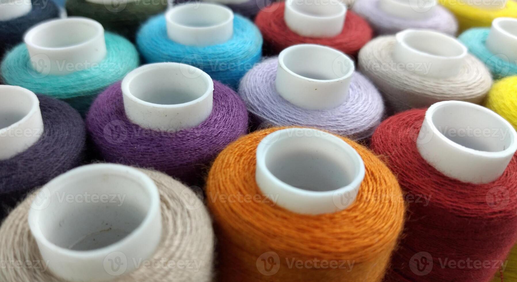 Rolls of multi-colored threads for tailors working in the garment embroidery sector photo