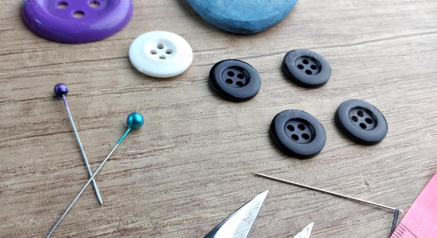 Sewing accessories on a wooden background Sewing accessories thread scissors pins tape measure. photo