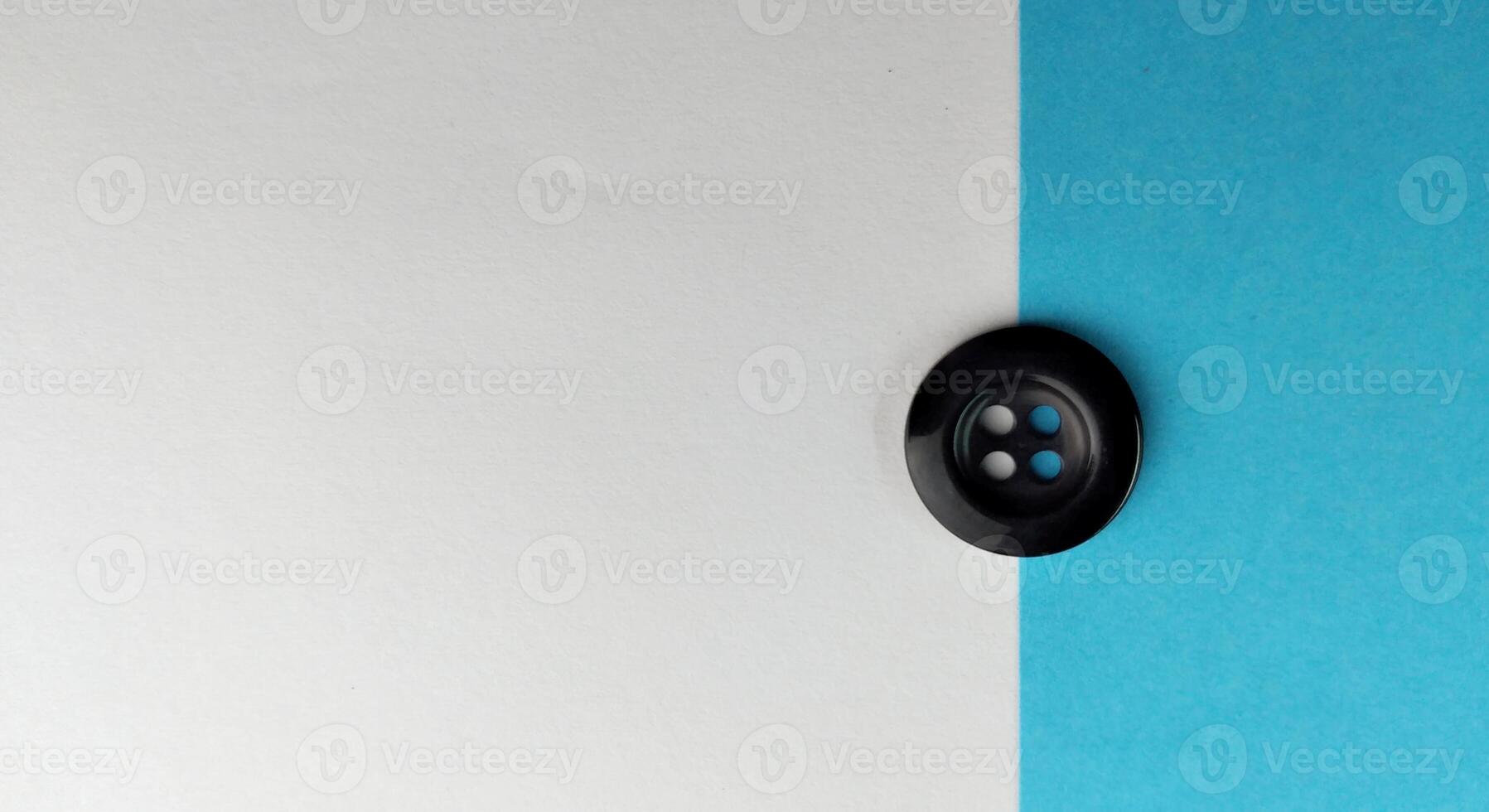 Black buttons on a white and blue background. Selective focus. photo