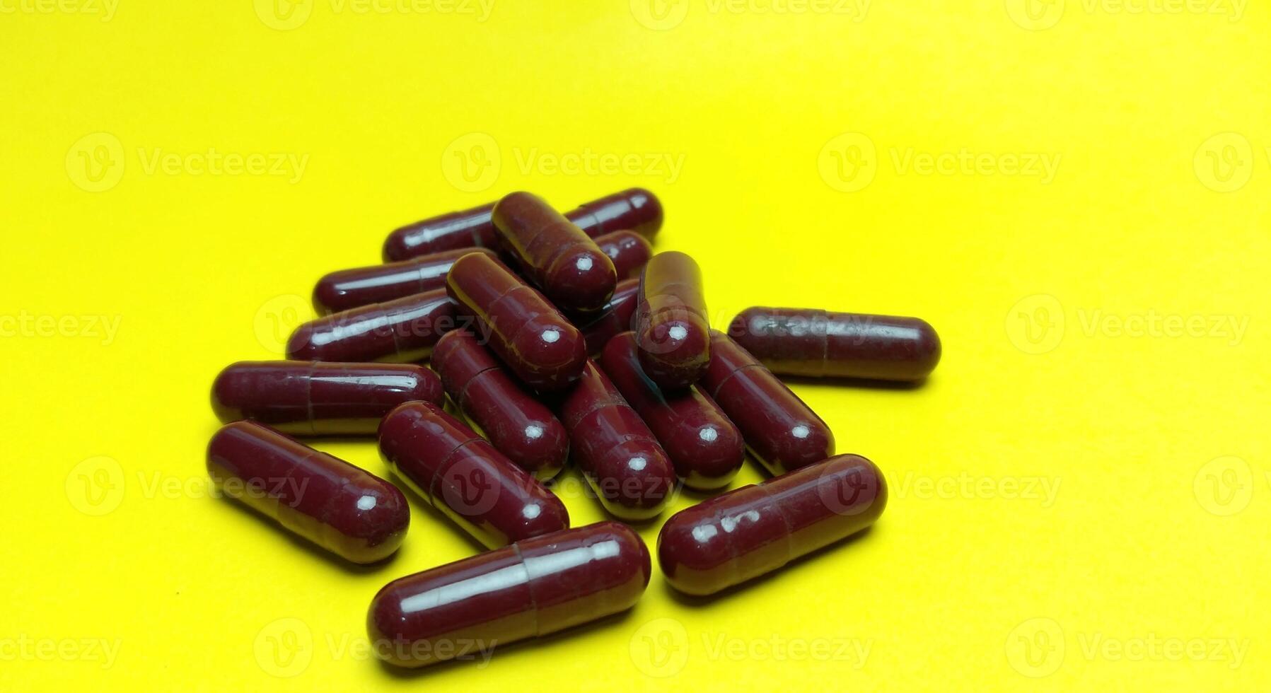 injectable pill medication on a yellow background photo