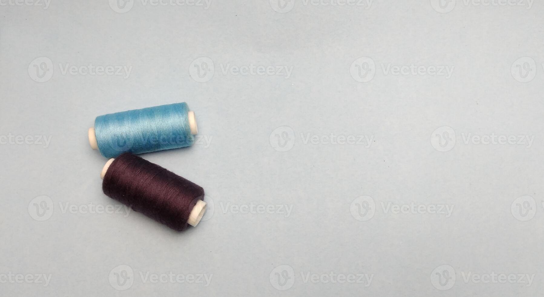 spools of thread on a blue background. place for text. photo