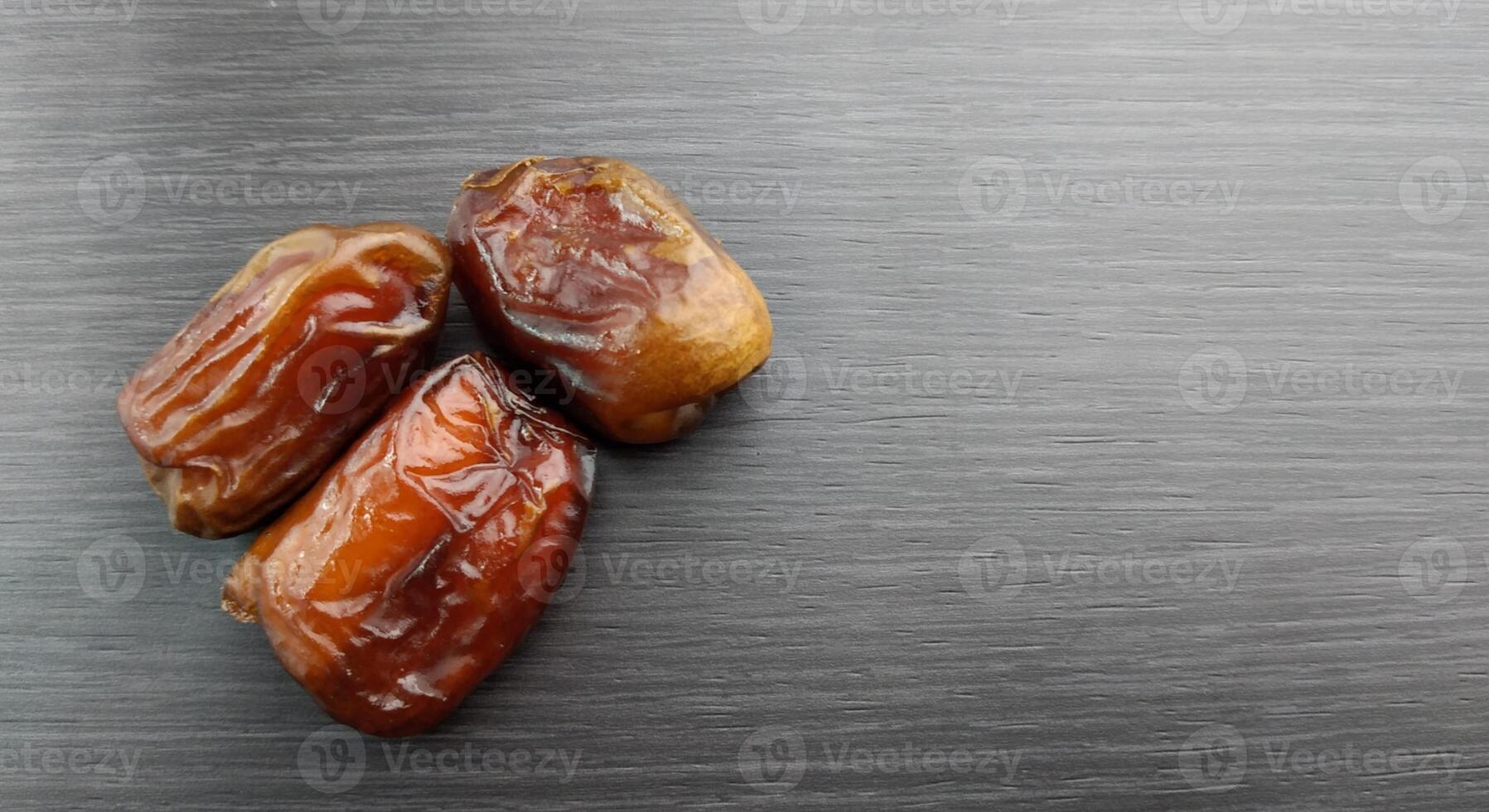 Dried dates on a black background, close-up, selective focus photo