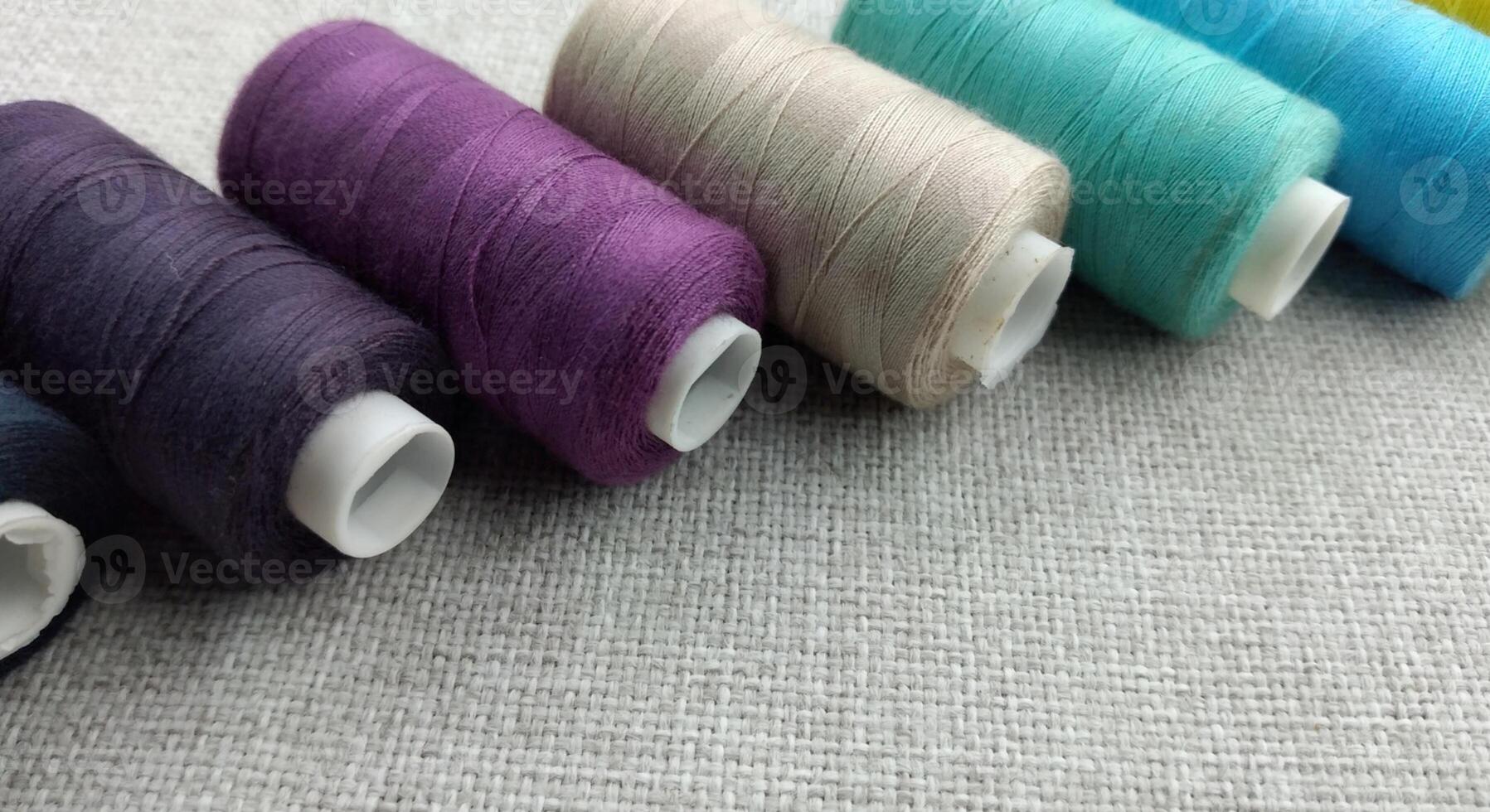 Rolls of multi-colored threads for tailors working in the garment embroidery sector photo