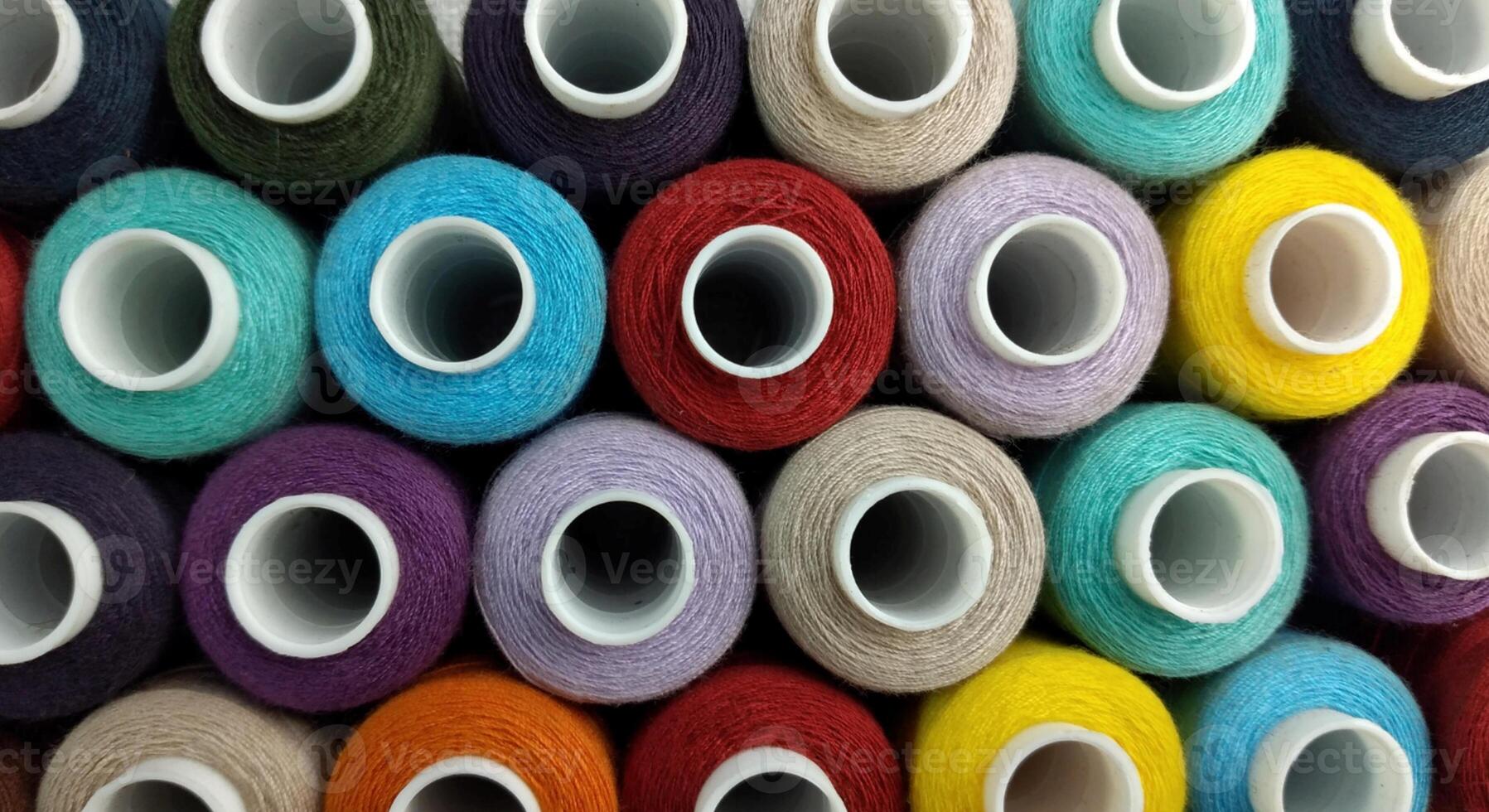 Rolls of multi-colored threads for tailors working in the garment embroidery sector photo