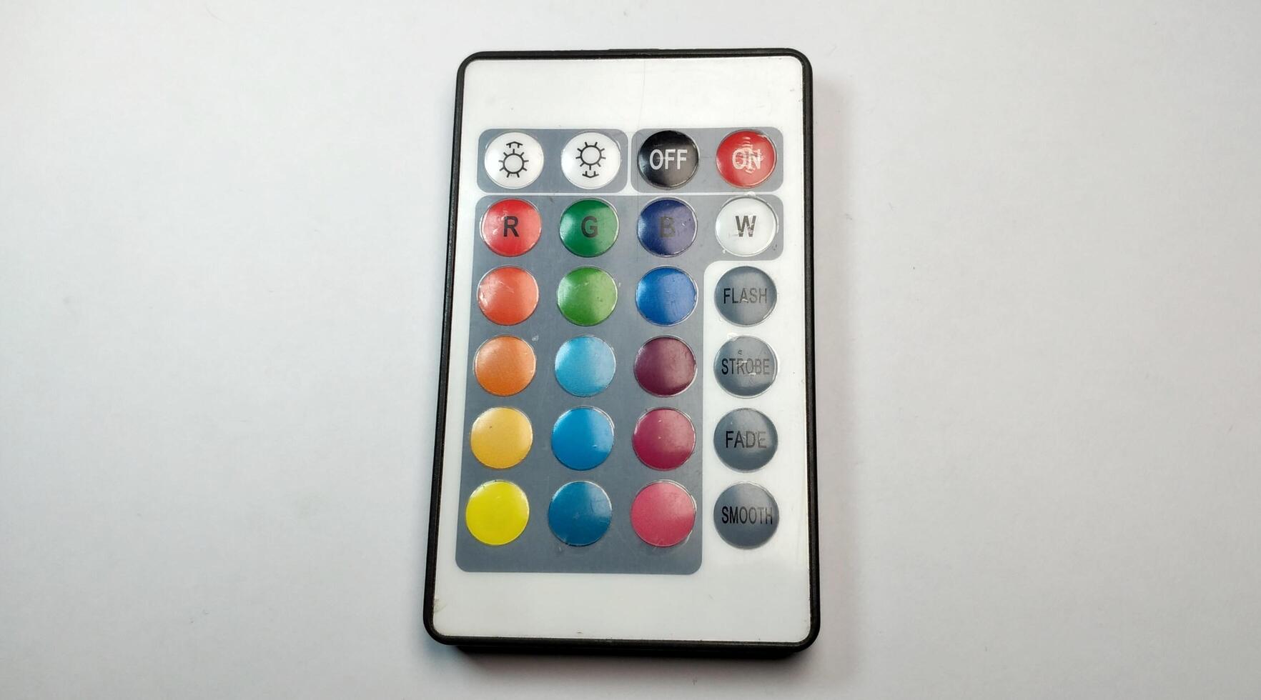 TV remote control with multicolored buttons isolated on white background. photo