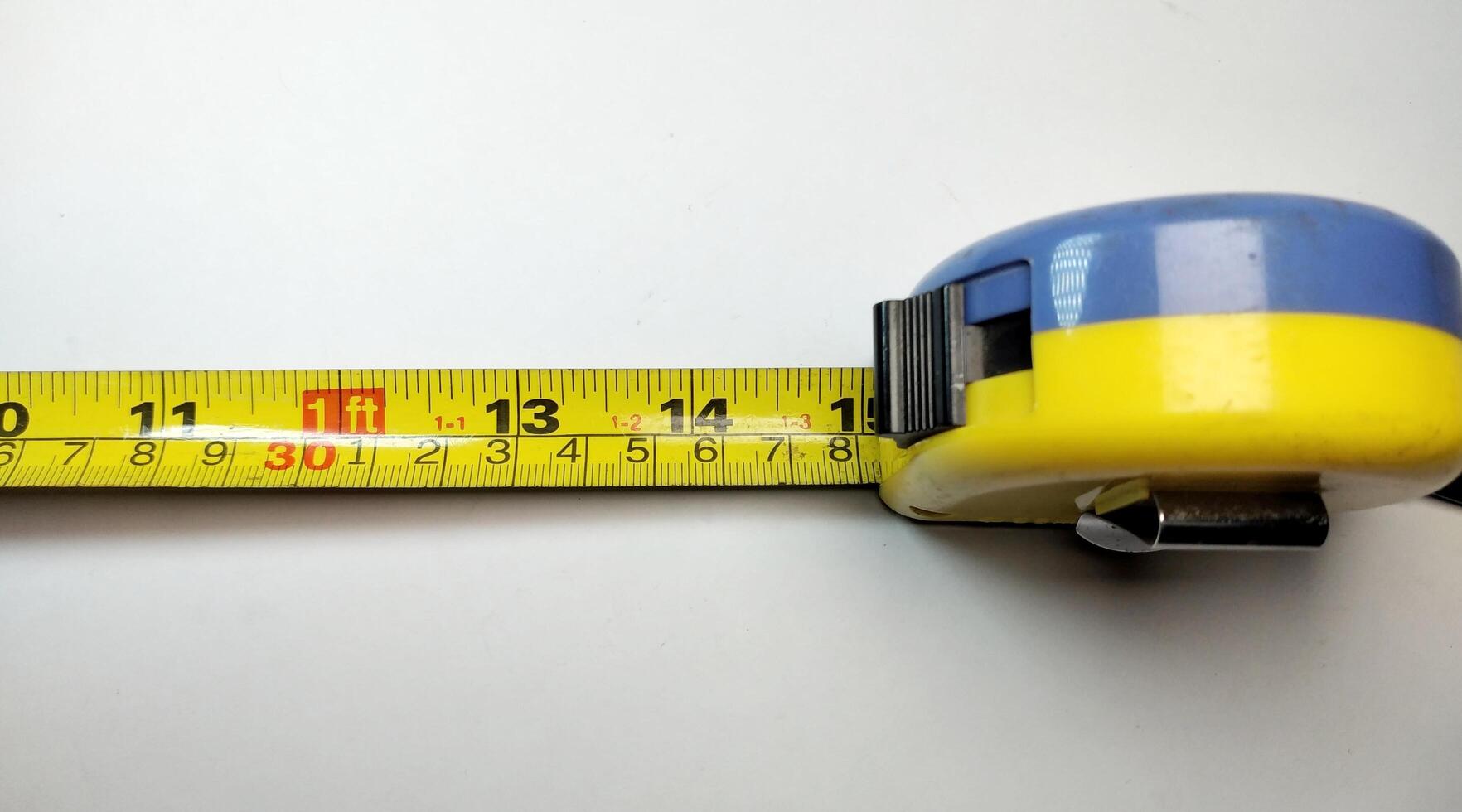 Close up of a tape measure on a white background with copy space photo