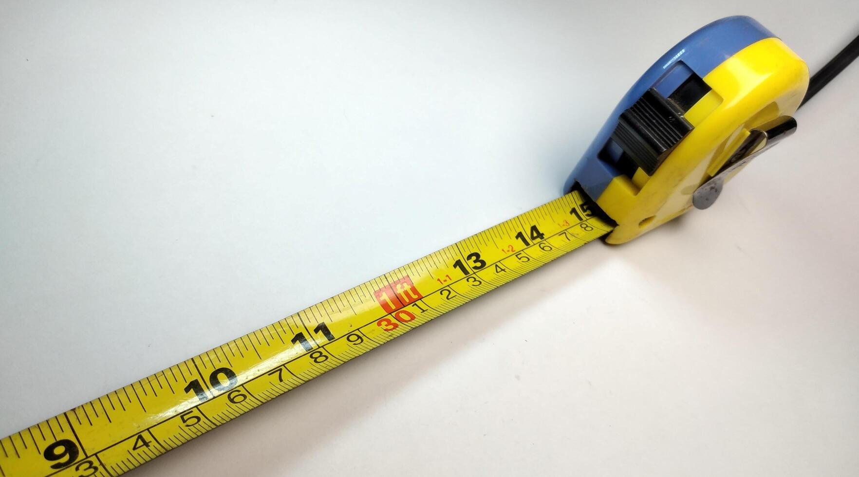 Close up of a tape measure on a white background with copy space photo