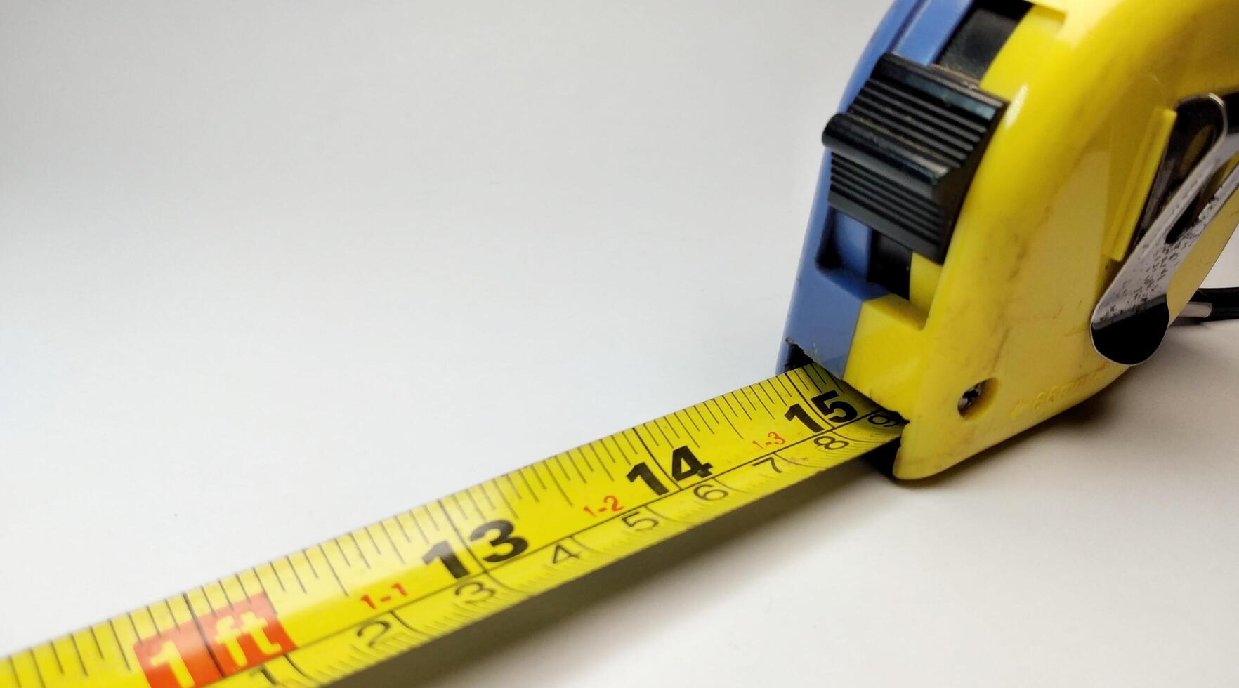 Close up of a tape measure on a white background with copy space photo