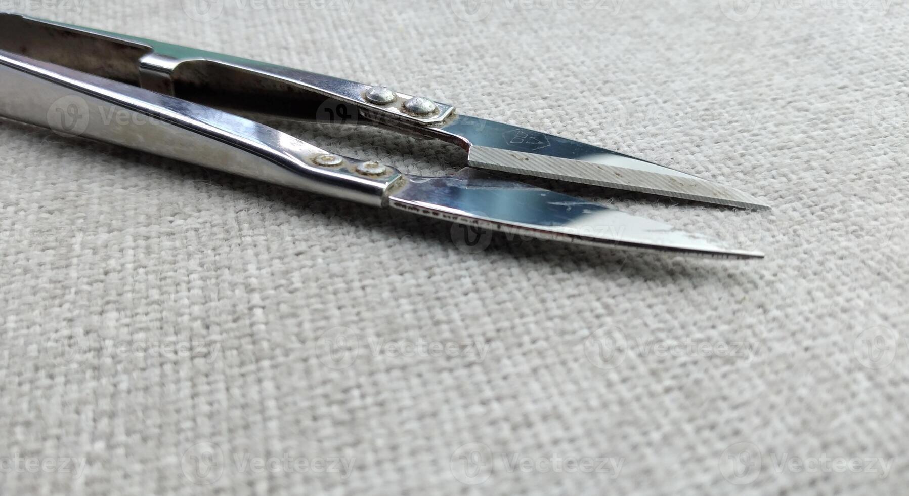 Old sewing scissors on a yellow background. View from above. Copy space. photo