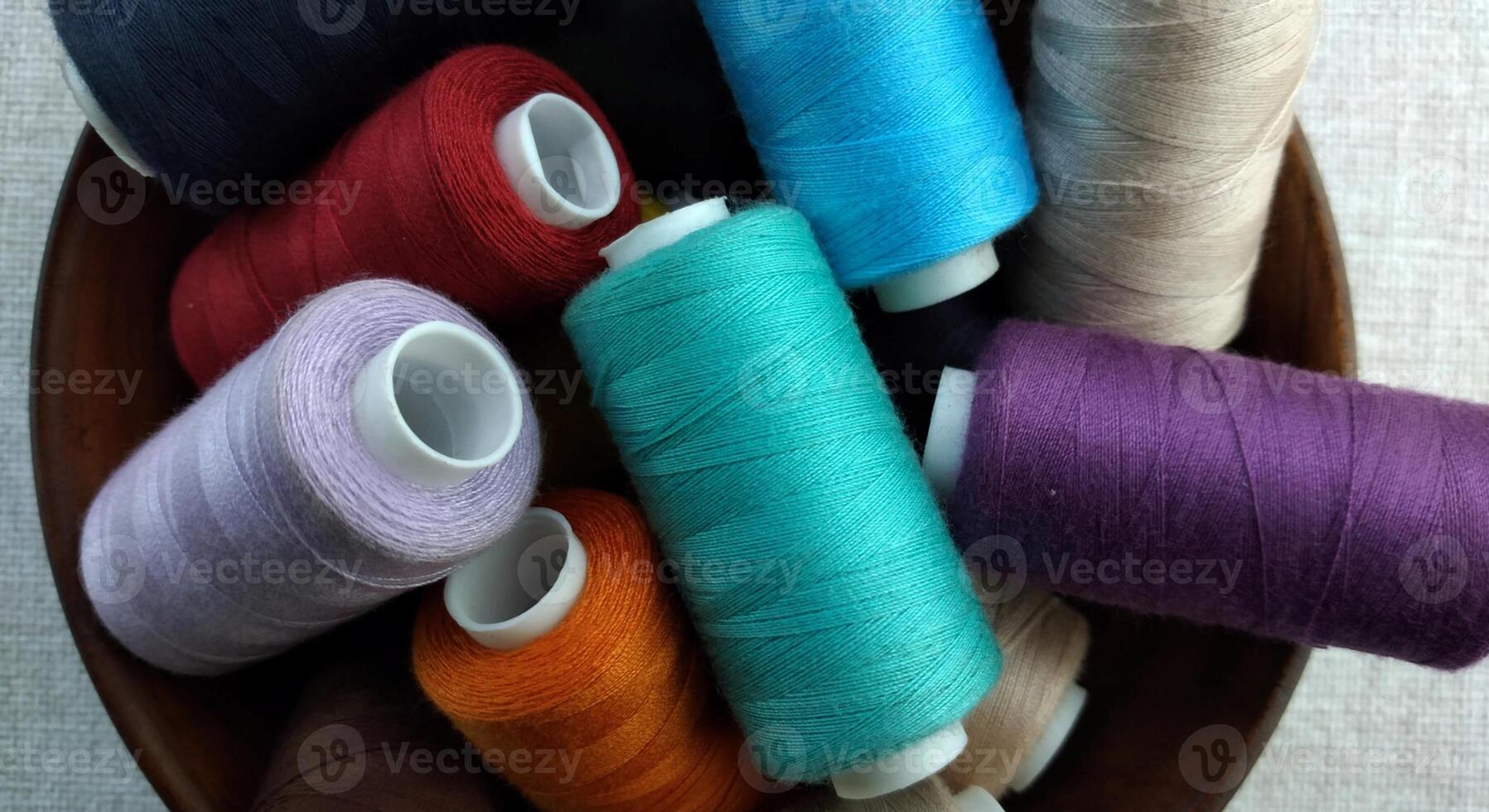 Rolls of multi-colored threads for tailors working in the garment embroidery sector photo