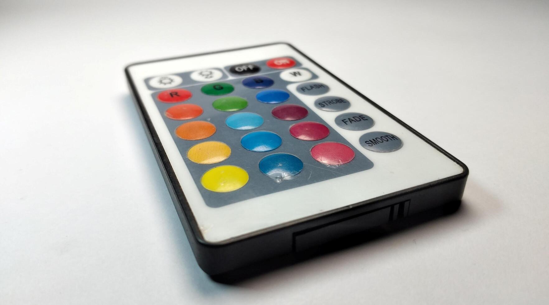 TV remote control with multicolored buttons isolated on white background. photo