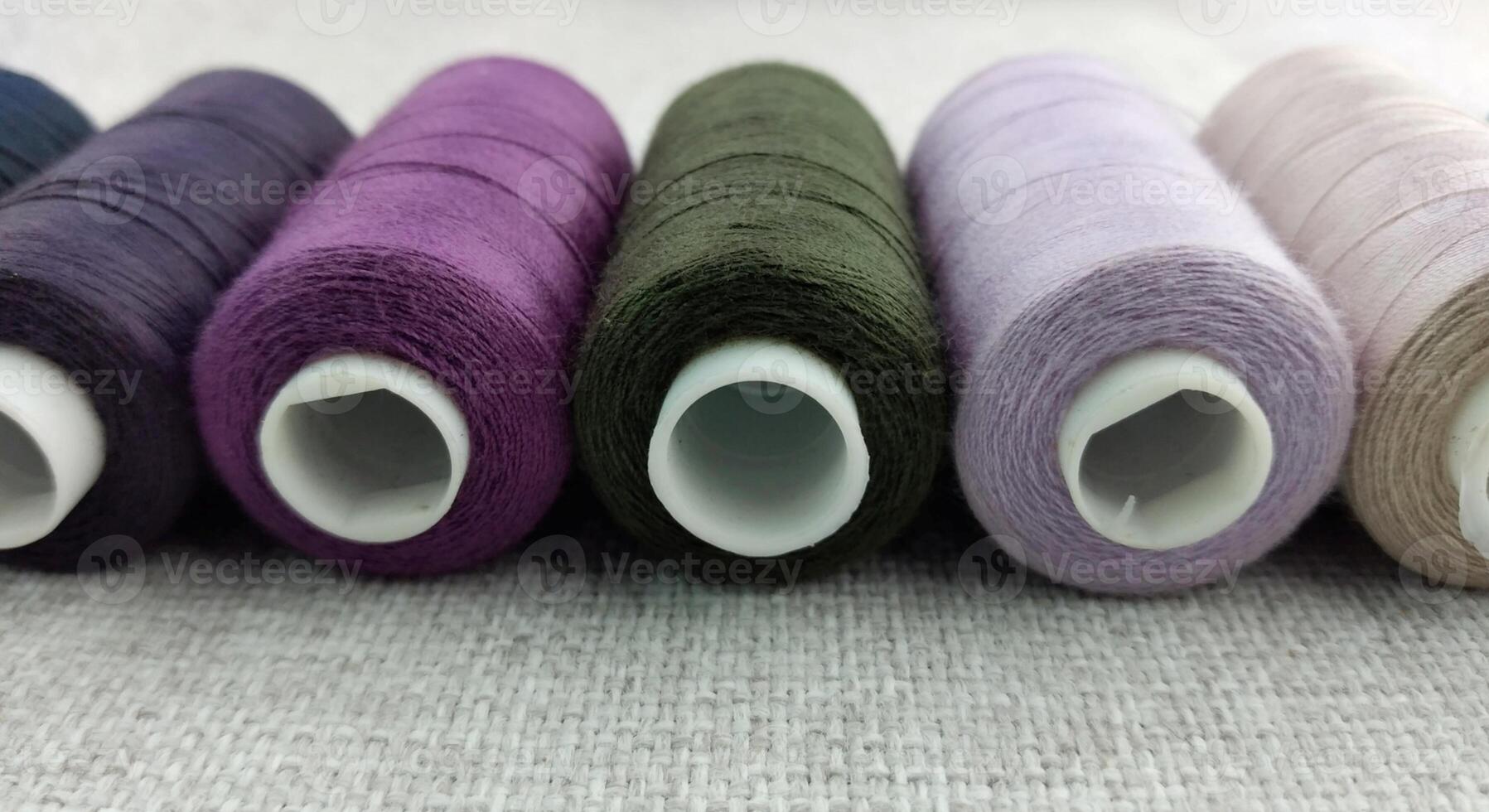 Rolls of multi-colored threads for tailors working in the garment embroidery sector photo