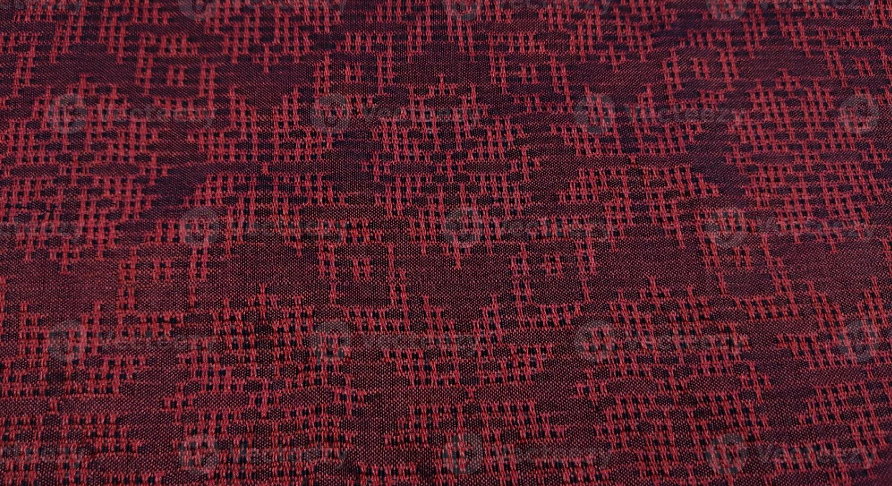 Texture, background, pattern. The fabric is red with a pattern of geometric figures. This is a detailed close-up of the fabric. photo