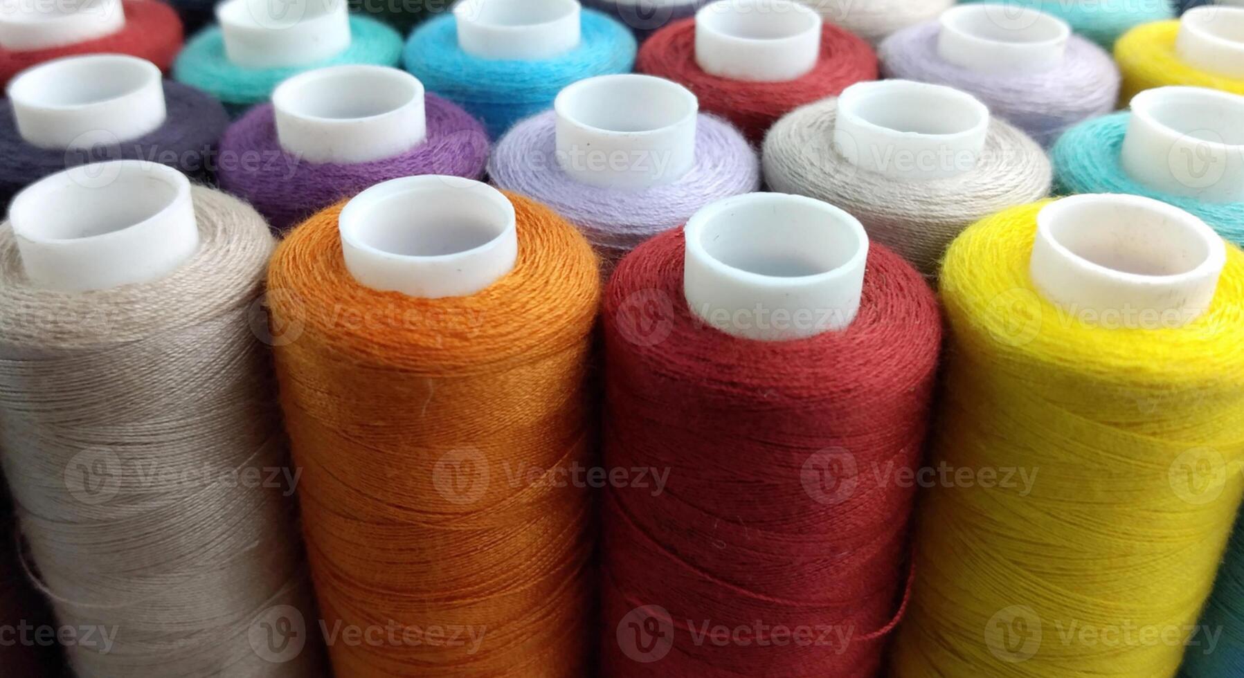 Rolls of multi-colored threads for tailors working in the garment embroidery sector photo