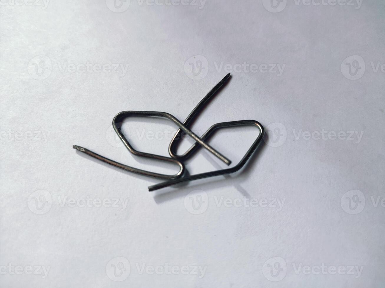 an s-shaped iron that is used to hang curtains and others photo