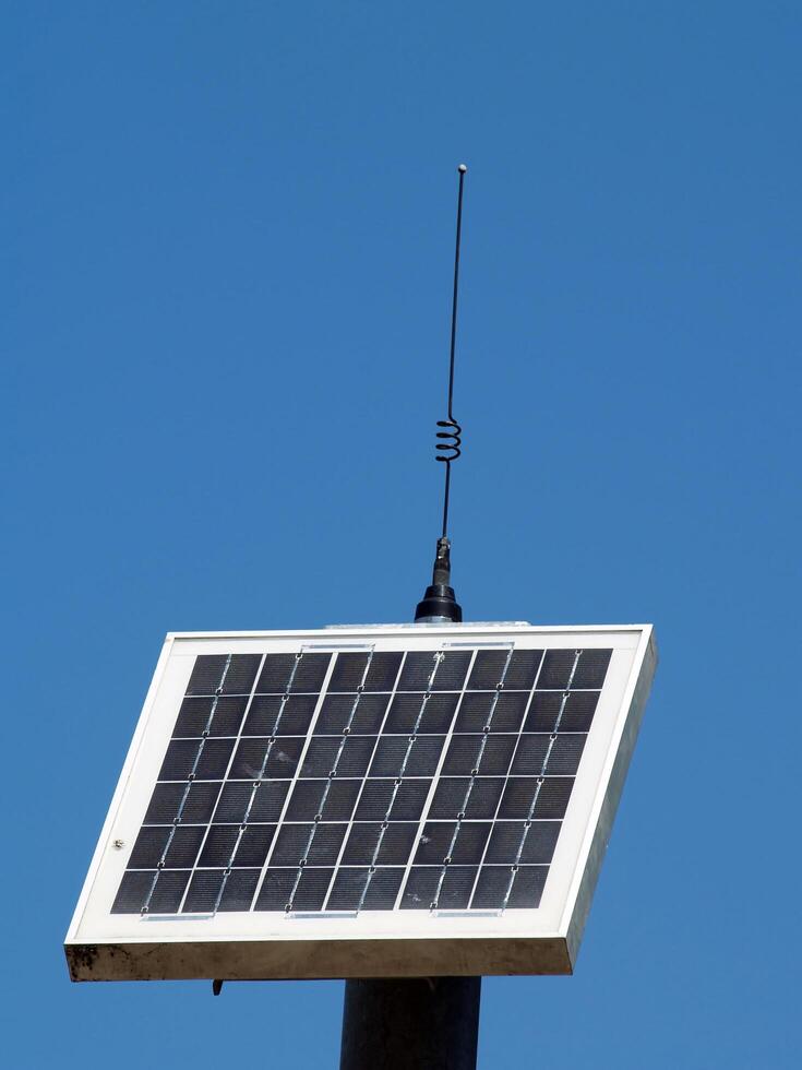 Folsom, CA, 2009 - Solar panel with antennae against blue sky photo