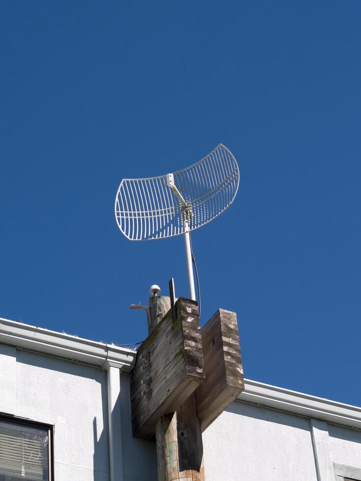 Berkeley, CA, 2007 - White Antenna against blue sky on building top photo