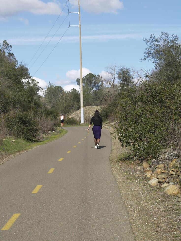 Folsom, CA, 2009 - Woman in Business Outfit Walking Bike Trail photo