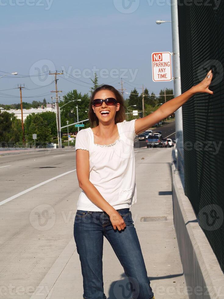Big Smile On Young Slim Caucasian Woman Outdoors On Sidewalk photo
