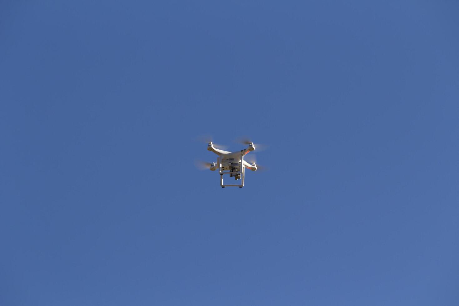 Cusco, Peru, 2015 - White Four Blade Drone With Camera In Blue Sky photo