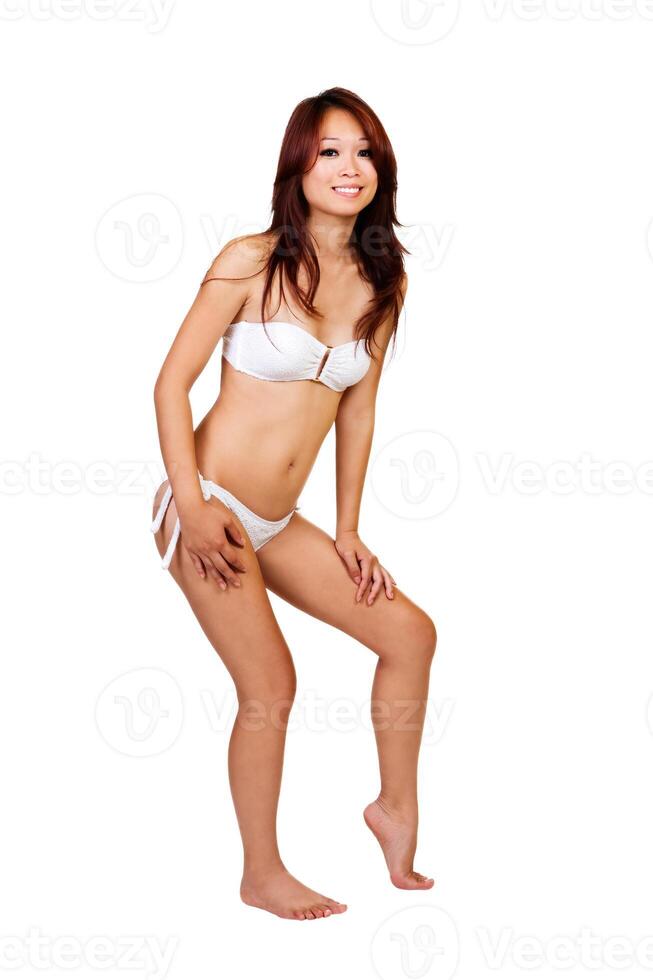 Slim Asian American Woman Standing In White Bikini photo