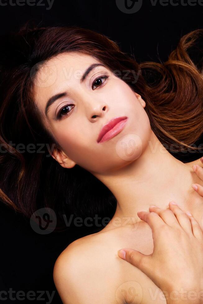 Bare Shoulders Portrait Of Reclining Hispanic Woman photo