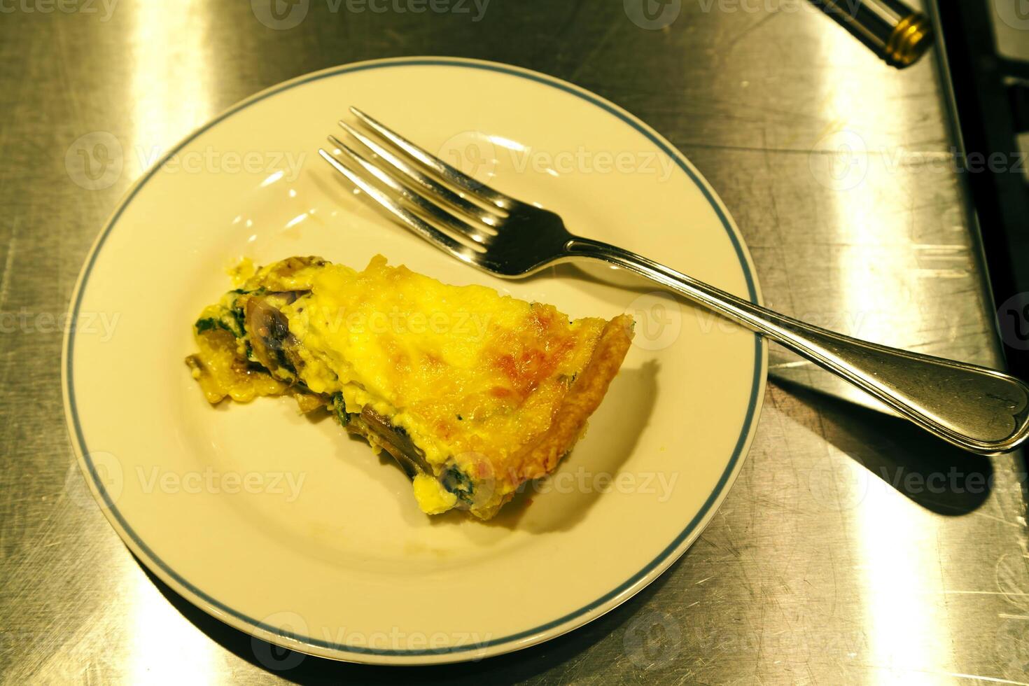 Piece Of Spinach And Mushroom Quiche On Plate photo