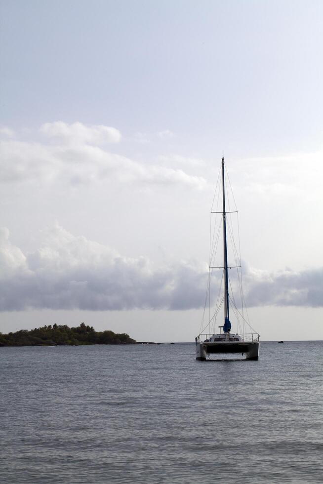 Kona, HI, 2011 - Catamaran sail boat at anchor in bay photo