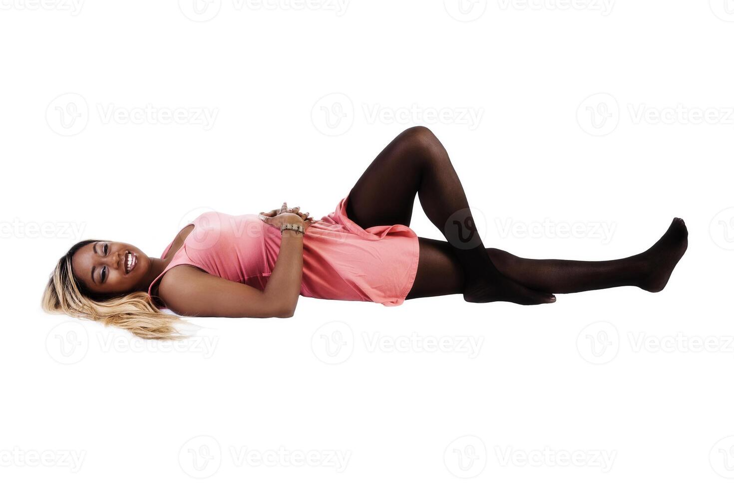 Smiling African American Woman Reclining On Back In Dress photo